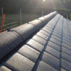 Interlocking plain tiles on the roof of a house extension