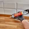 This image displays the Everbuild Everflex 200 Contractors LMA Silicone - White 295ml Being Applied