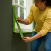 This image displays the FrogTape® Multi-Surface Masking Tape - 36mm x 41.1m Being used on a window frame
