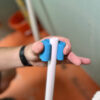 This image displays the OX Polyzip Flex C1 Cutter - 15 - 28mm Wrapping around a Pipe