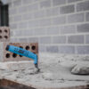 This image displays the OX Pro Brick Trowel Philadelphia Pattern - 10 250mm With material on it