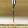 This image displays the Timco Twin-Cut C2 Floor-Fix Screws being drilled into a wooden substrate